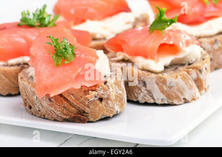 Sandwiches au saumon sur plaque blanche, vue en gros Banque D'Images