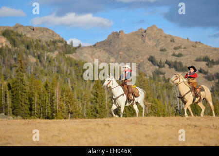 USA, Wyoming, deux jeunes cow-boys à cheval Banque D'Images