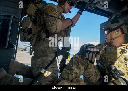 Le s.. Août O'Neil, un pararescueman dans l'Armée de l'air programme guerrier blessé ainsi qu'un membre du 58e Escadron de sauvetage, attendre le décollage dans un UH-60 Black Hawk, le 27 février 2015 à Nellis Air Force Base, Nevada La 66e rouge avec le 58e Escadron de sauvetage assisté dans les cérémonies d'ouverture de l'Armée de l'Air 2015 Essais du guerrier blessé. Les essais de l'Armée de l'air sont un événement sportif adapté visant à promouvoir le bien-être mental et physique des personnes gravement malades et blessés militaires et anciens combattants. Plus de 105 blessés, malades ou blessés, hommes et femmes de partout dans le pays Banque D'Images