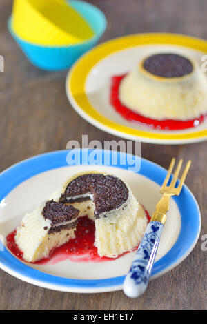 Mini Cheesecakes avec confiture de framboises et biscuit Banque D'Images