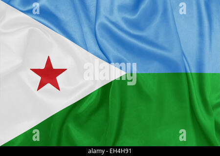 Djibouti - brandissant un drapeau national sur la texture de la soie Banque D'Images