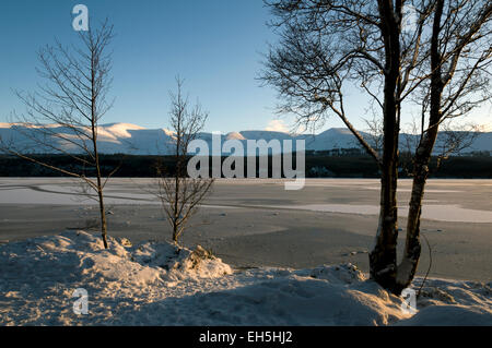 Les montagnes de Cairngorm sur la glace d'un Loch Morlich, près d'Aviemore, région des Highlands, Ecosse, Royaume-Uni Banque D'Images