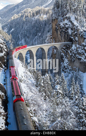 Le train rouge de l'Albula-Bernina Express Railway, Patrimoine Mondial de l'UNESCO sur le célèbre viaduc de Landwasser, Suisse, Europe Banque D'Images