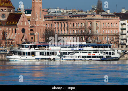 Bateau de croisière Danube, Budapest, Hongrie avec église calviniste en arrière-plan Banque D'Images