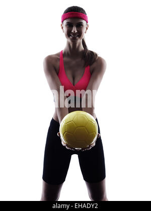 Une femme beach volley ball player silhouette en silhouette studio isolé sur fond blanc Banque D'Images