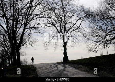 Un homme en silhouette marcher dans Hampstead Heath, Londres Banque D'Images