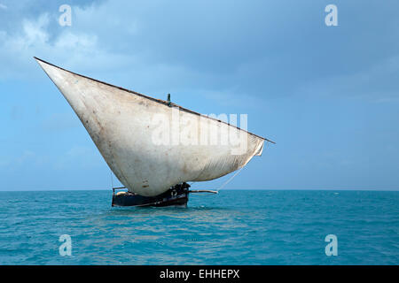 Voilier en bois (dhow) sur l'eau et des nuages, l'île de Zanzibar Banque D'Images