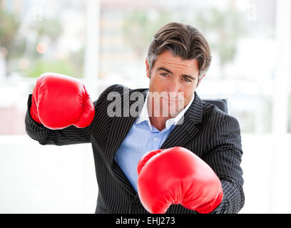 Furious businessman wearing boxing gloves Banque D'Images