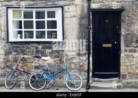 Vieille maison en pierre avec deux vélos appuyé contre le mur extérieur, à Oxford en Angleterre Banque D'Images