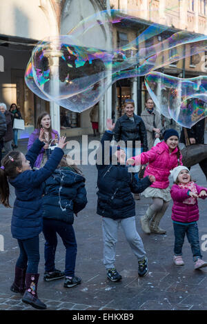 Enfants jouant avec des bulles géantes, Ferrara, Italie Banque D'Images