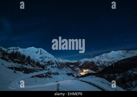 Vue aérienne de La Thuile village brillants dans la nuit, célèbre station de ski en Vallée d'aoste, Italie. Merveilleux ciel étoilé. Banque D'Images