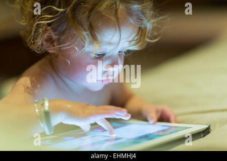 Caucasian baby using digital tablet Banque D'Images