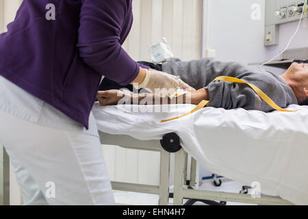 Patient subissant une tomodensitométrie (TDM) du cerveau (accident vasculaire cérébral (AVC)), l'hôpital de Bordeaux, France. Banque D'Images