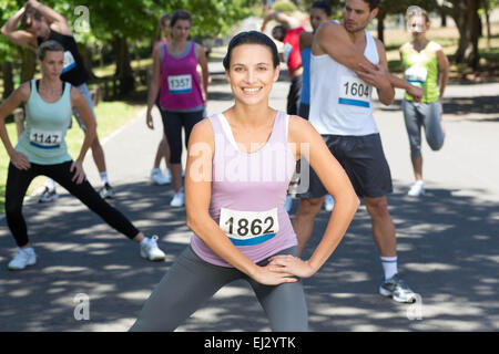 Smiling woman l'échauffement avant la course Banque D'Images