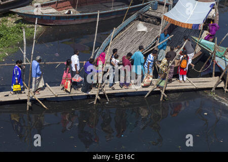 Dhaka, Bangladesh. Mar 20, 2015. Dhaka, Bangladesh, le 20 mars 2015 ; peuple bangladais voyageant par bateau sur l'eau de Bali pitch black river qui sont polluées par les eaux usées, la saleté et les produits chimiques toxiques flow.Les gens ne peuvent pas utiliser ces de l'eau. Un nouveau rapport DES NATIONS UNIES lancée à New Delhi le 20 mars à venir de la Journée mondiale de l'eau le 22 mars a mis en garde contre un besoin urgent de gérer l'eau de la planète plus durable et de mettre en lumière le problème de l'eau souterraine sur l'extraction, en particulier en Inde et en Chine. Le rapport affirme que la demande mondiale d'eau augmente de façon exponentielle, explique en grande partie par la croissance de la population. (Crédit Imag Banque D'Images