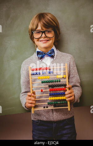 Boy holding address in front of blackboard Banque D'Images