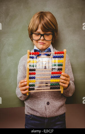 Portrait of cute little boy holding abacus Banque D'Images