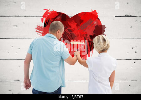 Plus de couple painting white wall Banque D'Images