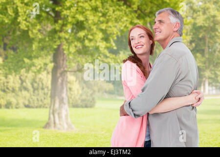 Image composite de casual couple hugging and smiling Banque D'Images