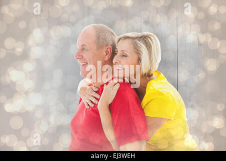 Composite image of mature couple hugging and smiling Banque D'Images