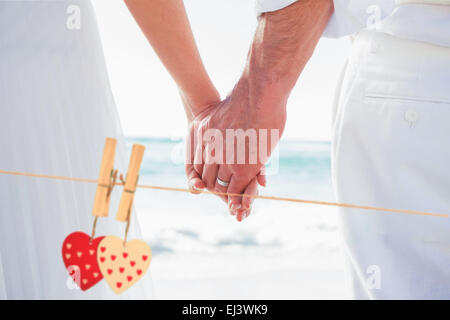Image composite de Bride and Groom holding hands up Banque D'Images