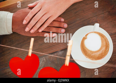 Image composite du couple holding hands à côté de cappuccino Banque D'Images