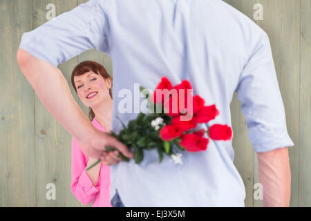 Image composite de man holding roses derrière lui Banque D'Images