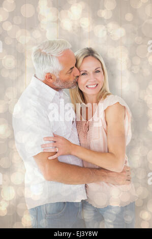 Image composite de l'homme affectueux baiser sa femme sur la joue Banque D'Images
