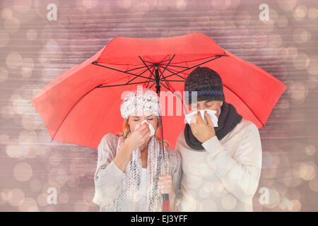 Image composite de couple in winter fashion éternuements under umbrella Banque D'Images