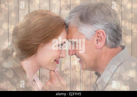 Image composite de casual couple smiling at each other Banque D'Images
