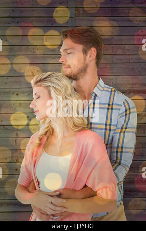 Image composite de l'attractive young couple embracing and smiling Banque D'Images