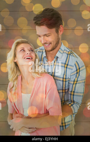 Image composite de l'attractive young couple embracing and smiling Banque D'Images