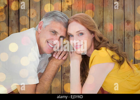 Image composite de casual couple smiling at camera Banque D'Images