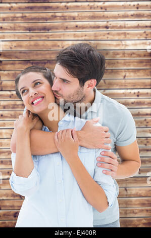 Image composite de cute couple hugging and smiling Banque D'Images
