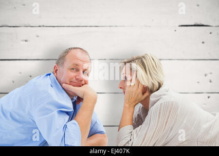 Image composite de mature couple lying and smiling Banque D'Images