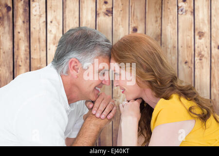 Image composite de casual couple smiling at each other Banque D'Images