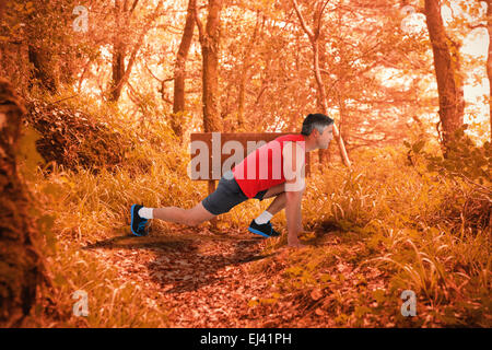 Image composite de l'homme en s'étendant ses jambes Banque D'Images