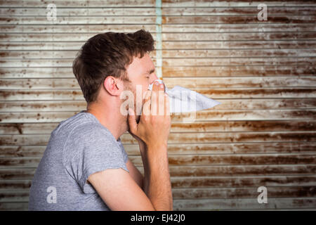 Image composite de close up side view of man blowing nose Banque D'Images