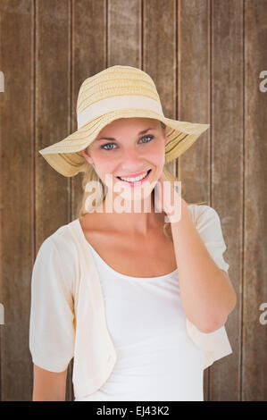 Composite image jeune couple smiling at camera in sunhat Banque D'Images