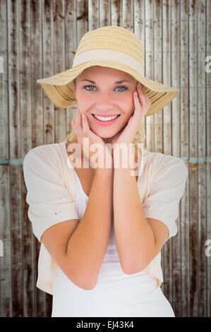 Composite image jeune couple smiling at camera in sunhat Banque D'Images