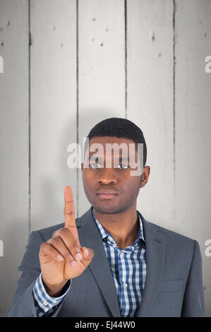 Composite image of businessman pointing Banque D'Images