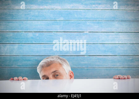 Image composite de businessman peeking plus de 24 Banque D'Images