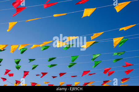 Bunting, colorée drapeaux de parti, sur un ciel bleu. Banque D'Images