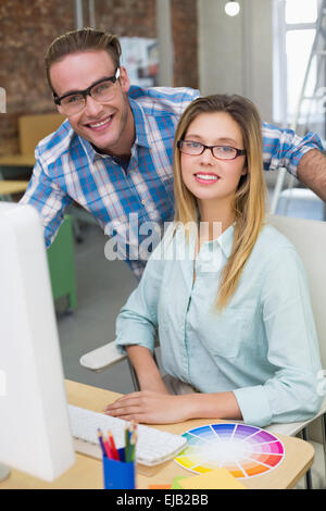 Portrait of smiling photo editors in office Banque D'Images