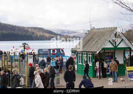 Le lac Windermere, Cumbria, Royaume-Uni. 24 mars, 2015. Météo : bateau de croisière arrive à l'embarcadère à l'atterrissage à Bowness-on-Windermere. Les touristes de profiter du soleil avec le dernier de la neige sur la haute lande Crédit : Gordon Shoosmith/Alamy Live News Banque D'Images