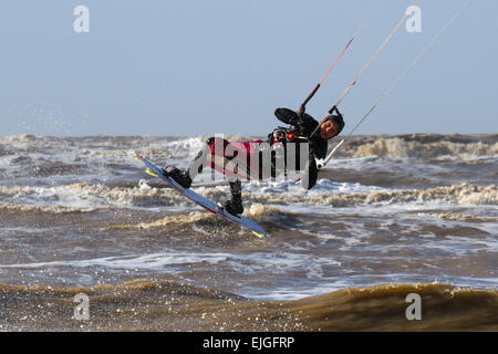 Southport, Merseyside, d'Ainsdale, UK 26 Mars, 2015. UK Météo à plage Kite Surf d'Ainsdale zone-sur-Mer avec de fortes marées et de grands vents. Un kiteboarder exploiter le pouvoir de le vent fort avec une grande aile de traction contrôlable propulsé à travers la marée, sur un kiteboard. Conseil de Sefton sont maintenant délivrer les licences pour l'utilisation de Kitesurfing à plage d'Ainsdale. Credit : Mar Photographics/Alamy Live News Banque D'Images