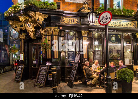 Les personnes qui boivent à l'extérieur de la nuit au pub de Salisbury, Londres, Angleterre Banque D'Images