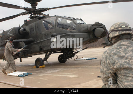 Le Sgt. Kenneth Darmer, un AH-64D armement, réparateur électriques et avioniques avec Co. D, 4e Bataillon, 2e d'ATK CAB, prépare un avion Apache pour son prochain cycle de cuisson au cours de la formation à l'incendie, Rodriguez Vivre complexe le 21 janvier. Au cours de l'événement de formation, Darmer et son équipe ont travaillé sur l'avant d'armement et d'essence, ou FARP, et a aidé à charger les Apaches de munitions et de carburant. Banque D'Images