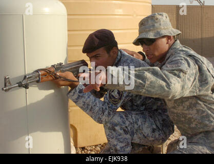 Le s.. Damian Remijio, demande à un agent de la Police nationale affectés à la 3e Brigade, 1NP NP pour maintenir la division en question une porte pendant un événement de formation, le 24 juin, à la base d'opérations avancée marteau, Iraq, situé à l'extérieur de l'est de Bagdad. Crédit Photo : Sgt. 1re classe Alex Licea Training Academy prépare le personnel de l'ISF pour protéger, maintenir les progrès de sécurité /-news/2009/07/01/23756-formation-academy - Prépare-isf-personnel-de-Protect-conserver-security-values/ ?ref =home-Titre-titre4 Banque D'Images