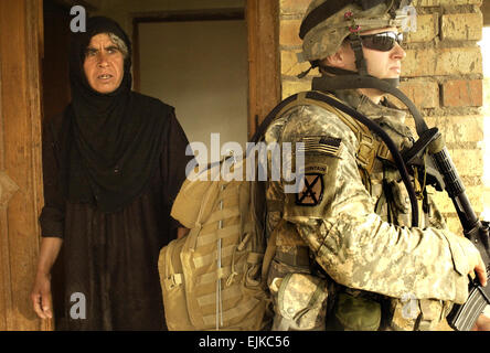 Un soldat de l'armée américaine fournit la sécurité à l'extérieur d'une maison pendant une patrouille à pied de localiser trois soldats disparus à Al Thobat, l'Iraq, le 18 mai 2007. Le soldat est affecté à la Compagnie Alpha, 4e Bataillon, 31e Régiment d'infanterie, 2e Brigade Combat Team, 10e Division de Montagne Light Infantry. Le Sgt. Tierney Nowland, de l'armée américaine. Banque D'Images